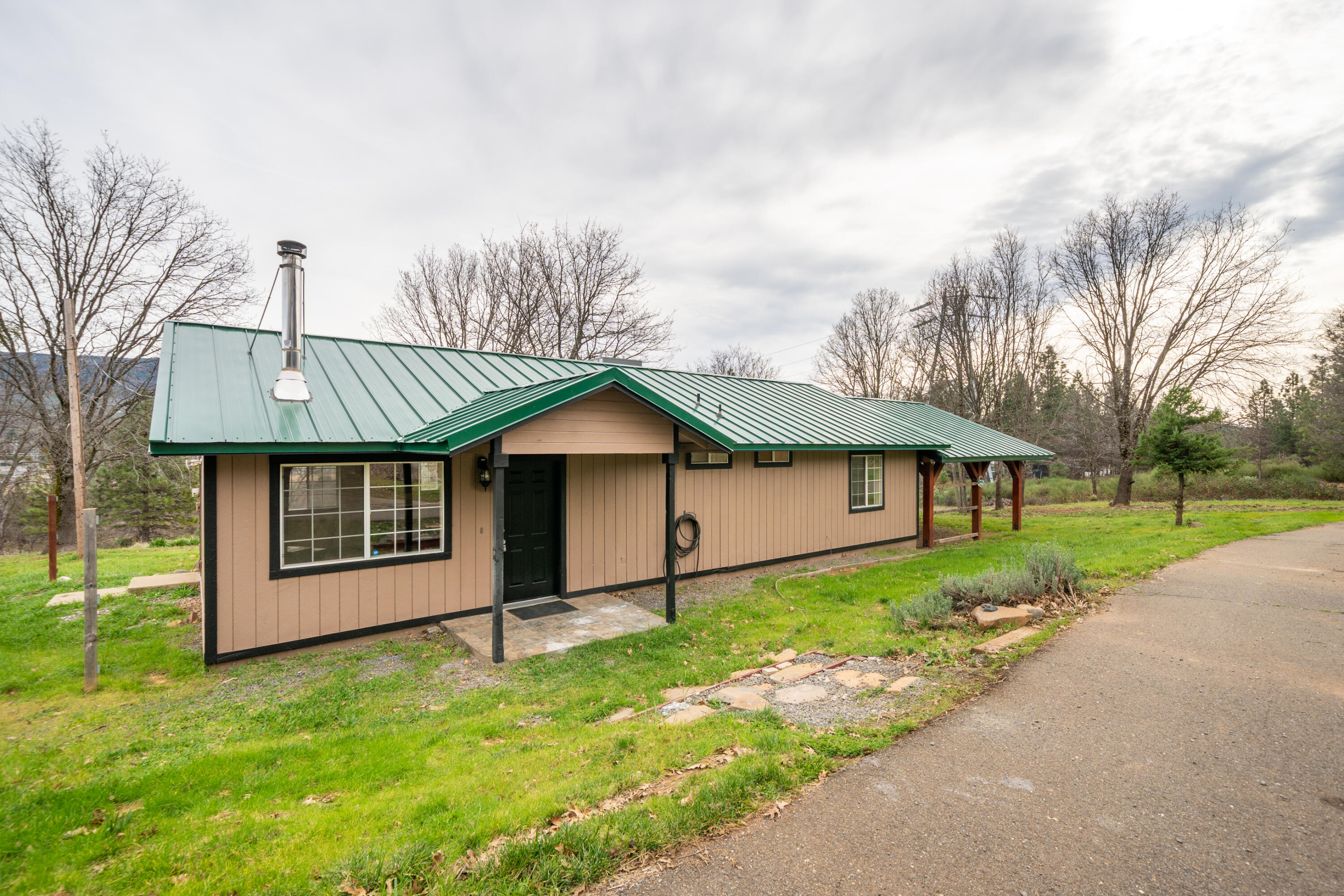 29800 Ranch Road Montgomery Creek, CA 96065 - Photo 9 of 74 a front view of a house with a yard and garage