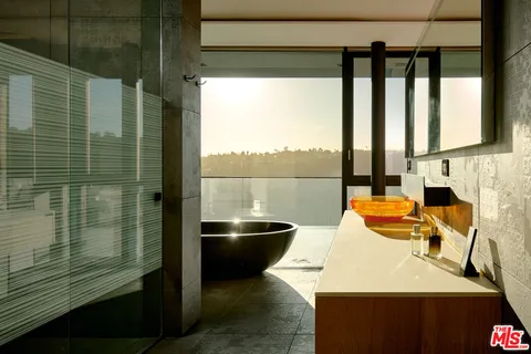 a bathroom with a sink and a large window