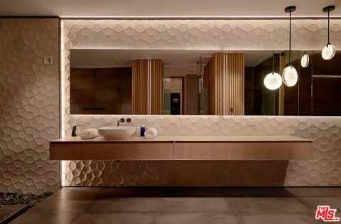 a front view of a house with a fountain