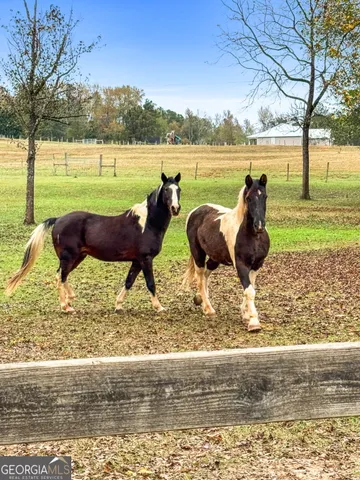 a view of house with outdoor space and deck