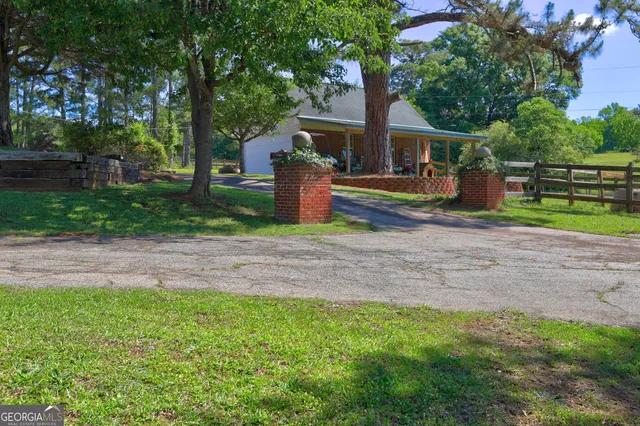 a kitchen with a sink and large windows