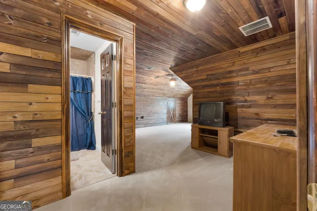 a view of a house with a yard and potted plants
