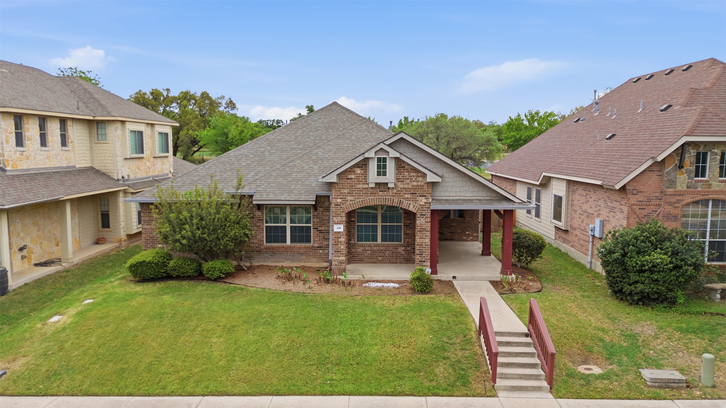 339 Sycamore Street Georgetown, TX 78633 - Photo 1 of 28 View of front of house with a front lawn, covered porch, brick siding, and a shingled roof