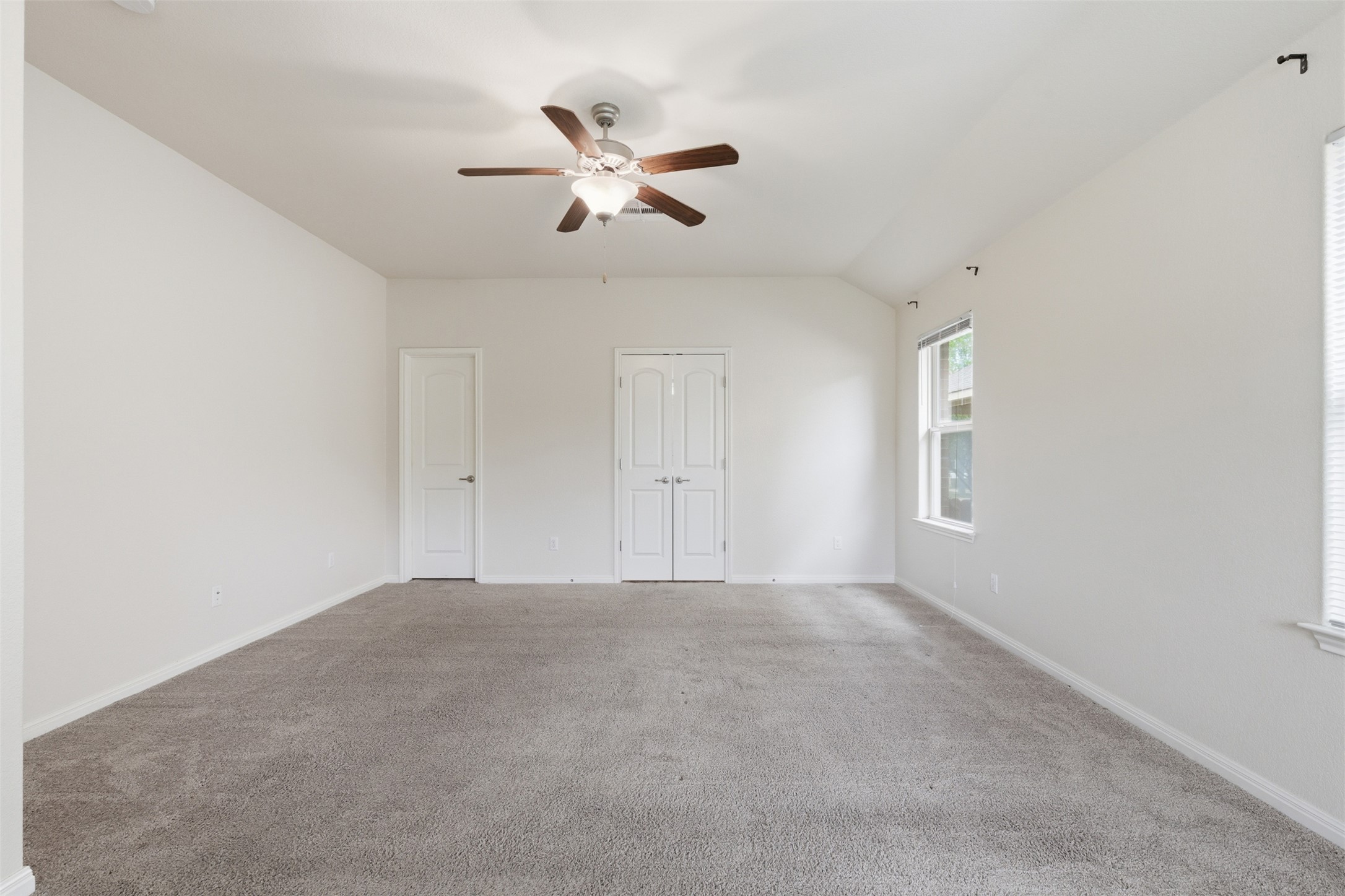 339 Sycamore Street Georgetown, TX 78633 - Photo 13 of 28 Unfurnished bedroom featuring carpet flooring, ceiling fan, a closet, and lofted ceiling