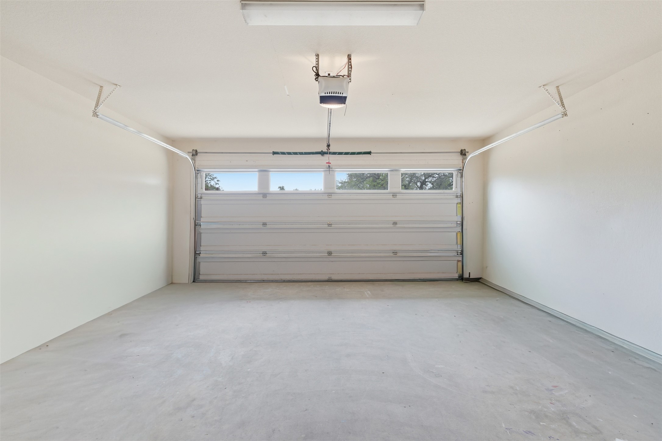 339 Sycamore Street Georgetown, TX 78633 - Photo 23 of 28 Garage featuring a garage door opener