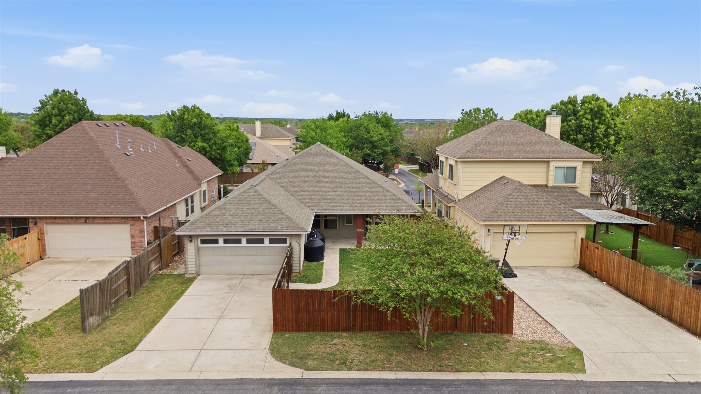 339 Sycamore Street Georgetown, TX 78633 - Photo 25 of 28 View of front of home with a garage, a shingled roof, driveway, a chimney, and a residential view