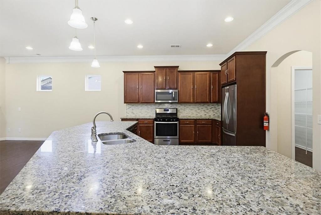 314 Boulder Run Hiram, GA 30141 - Photo 5 of 31 a kitchen with stainless steel appliances granite countertop a refrigerator sink and stove