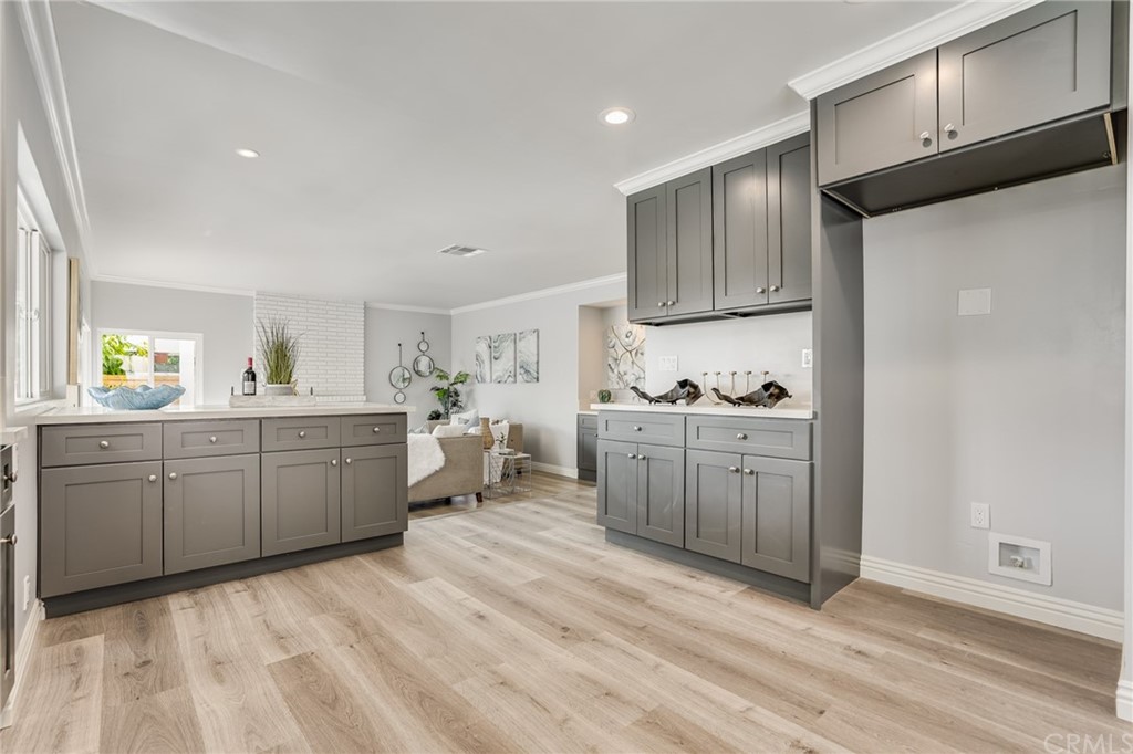 21626 Fairwind Lane Diamond Bar, CA 91765 - Photo 11 of 44 a kitchen with stainless steel appliances kitchen island granite countertop a refrigerator a sink a stove and white cabinets with wooden floor