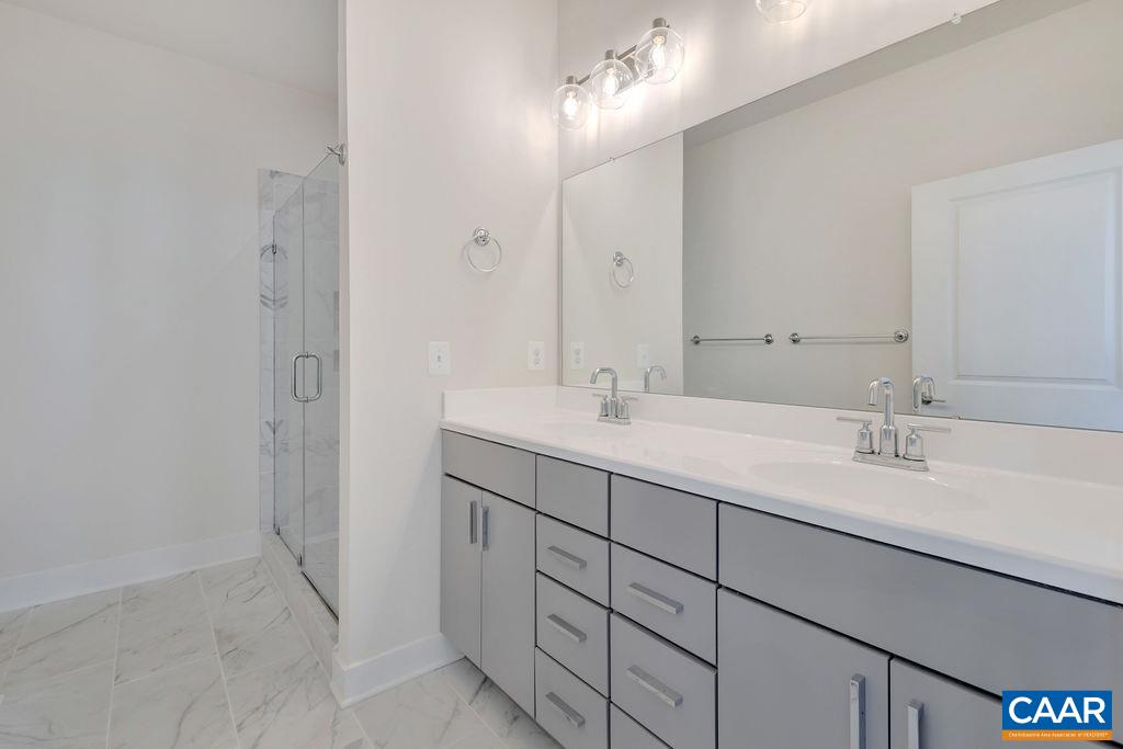 3254 Horizon Road Charlottesville, VA 22902 - Photo 18 of 32 a bathroom with a double vanity sink and a mirror