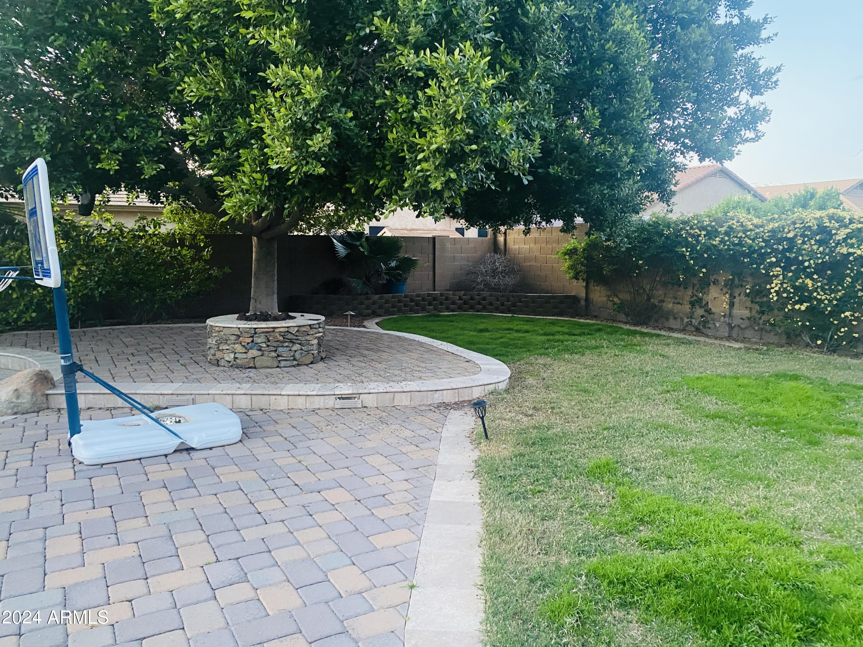 5230 West Red Bird Road Phoenix, AZ 85083 - Photo 17 of 26 a view of a backyard with plants and a fountain