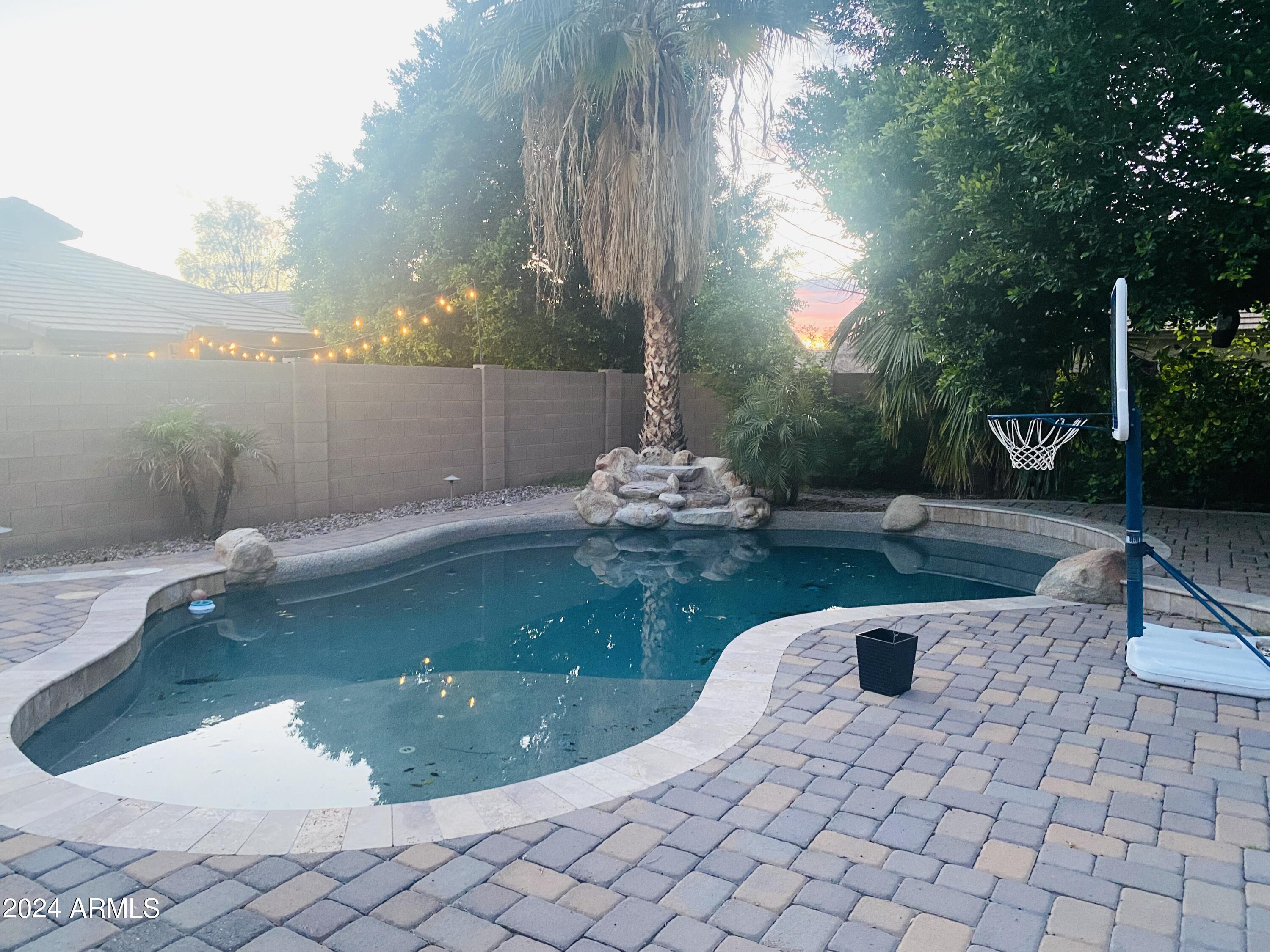 5230 West Red Bird Road Phoenix, AZ 85083 - Photo 19 of 26 a swimming pool with wooden fence
