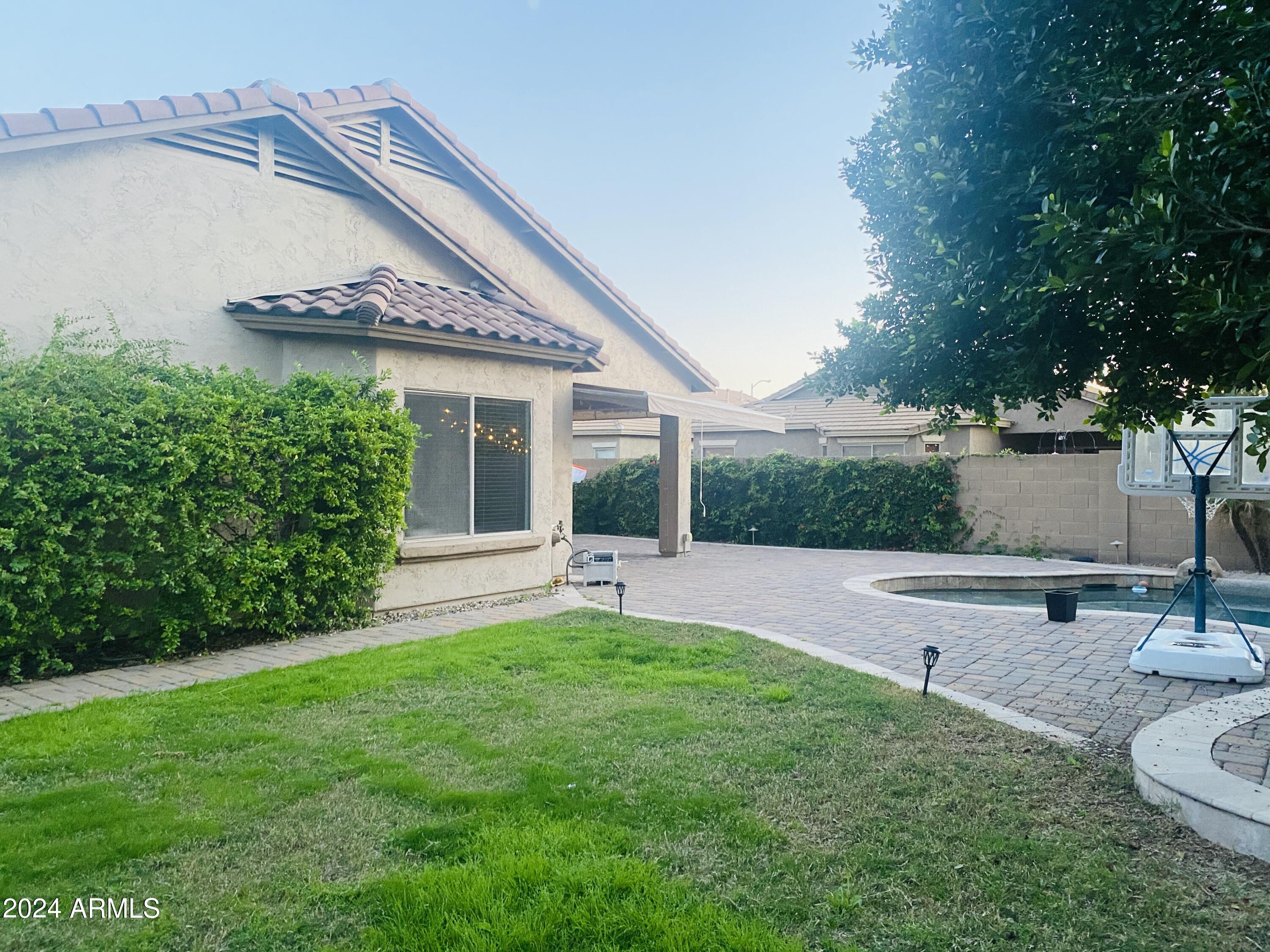 5230 West Red Bird Road Phoenix, AZ 85083 - Photo 20 of 26 a view of a house with a yard potted plants and a table