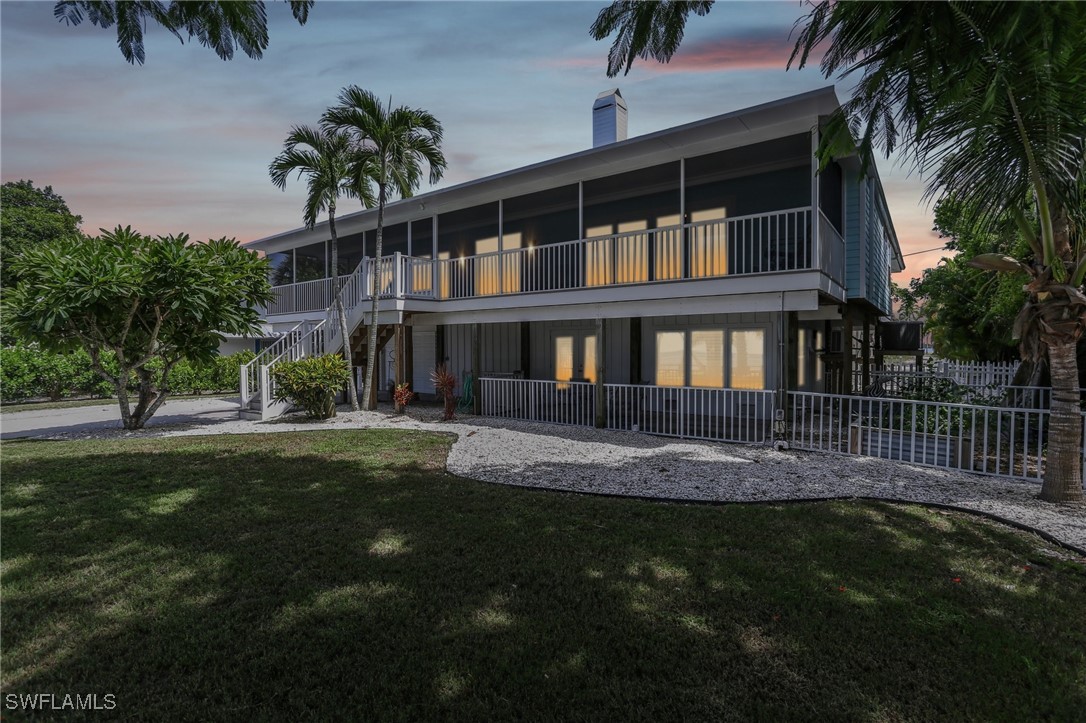 8335 Main Street Bokeelia, FL 33922 - Photo 3 of 47 a front view of a house with a garden