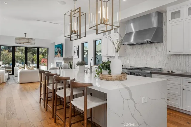 a kitchen with stainless steel appliances kitchen island granite countertop a table and chairs in it