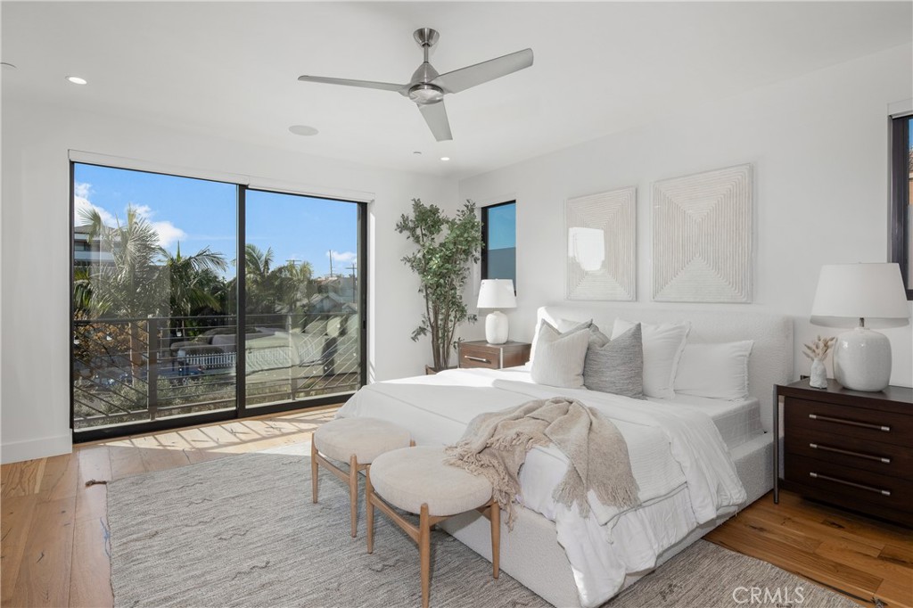 1004 Huntington Street Huntington Beach, CA 92648 - Photo 21 of 46 a bedroom with a large bed and a glass window