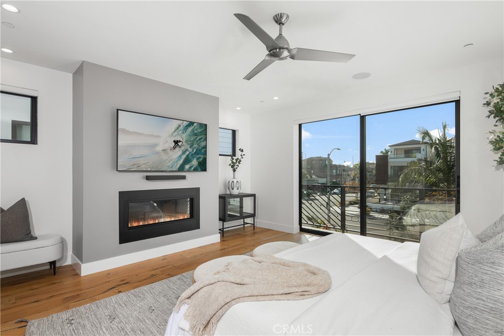 1004 Huntington Street Huntington Beach, CA 92648 - Photo 22 of 46 a bedroom with a bed and a fireplace