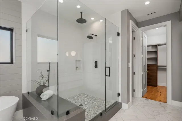 a bedroom with a bed and a night stand