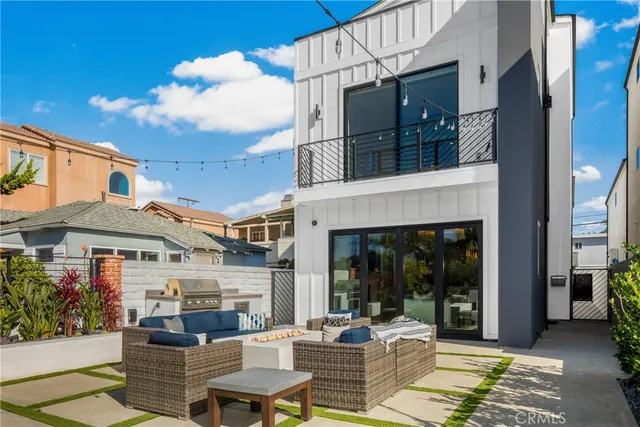 a patio with sofas table and chairs