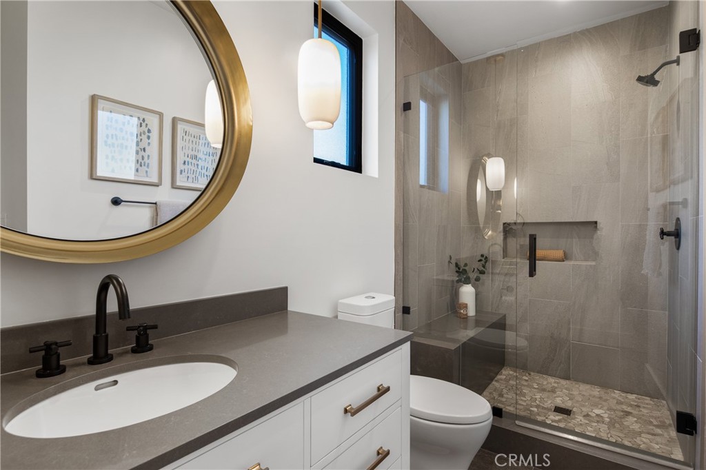 1004 Huntington Street Huntington Beach, CA 92648 - Photo 32 of 46 a bathroom with a sink a toilet and a mirror