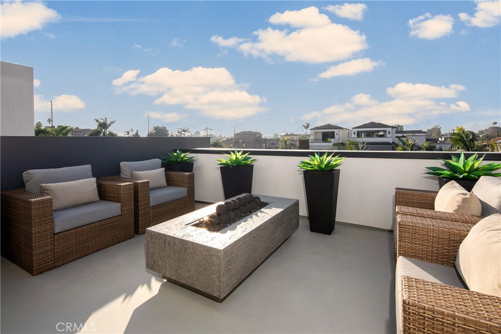 1004 Huntington Street Huntington Beach, CA 92648 - Photo 38 of 46 a view of a roof deck with couches and potted plants