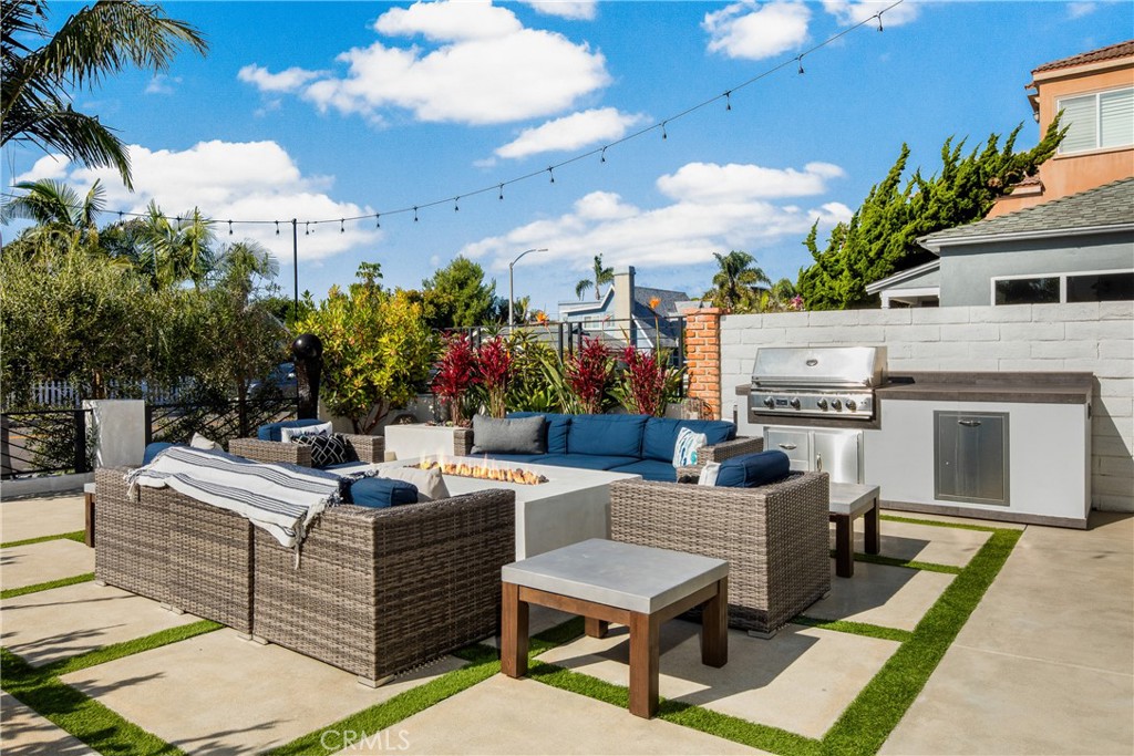 1004 Huntington Street Huntington Beach, CA 92648 - Photo 4 of 46 a view of a patio with couches table and chairs potted plants and palm tree