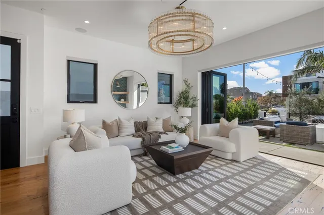 a kitchen with stainless steel appliances granite countertop a stove oven a refrigerator a sink and a dining table with wooden floor