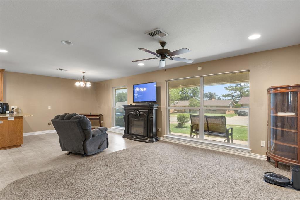 4504 Jennings Avenue Wichita Falls, TX 76310 - Photo 5 of 26 a living room with furniture a fireplace and a flat screen tv