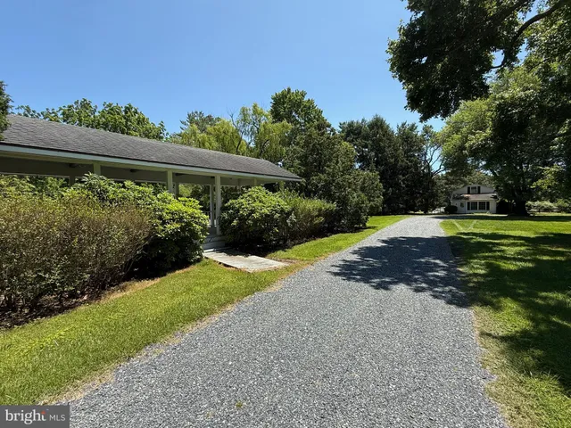 a living room with furniture a fireplace and a chandelier