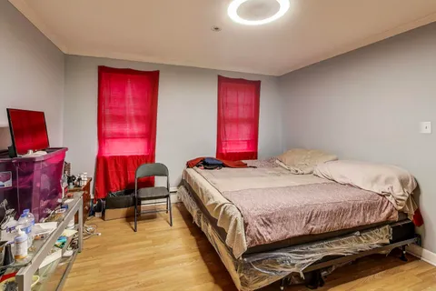 a bedroom with a bed and a window