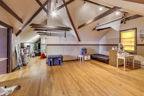 a view of a room with wooden floor