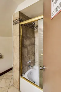 a bathroom with a shower and a bathtub