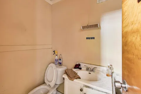 a bathroom with a sink and mirror with bathtub