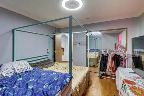 a bedroom with a bed and a walk in closet