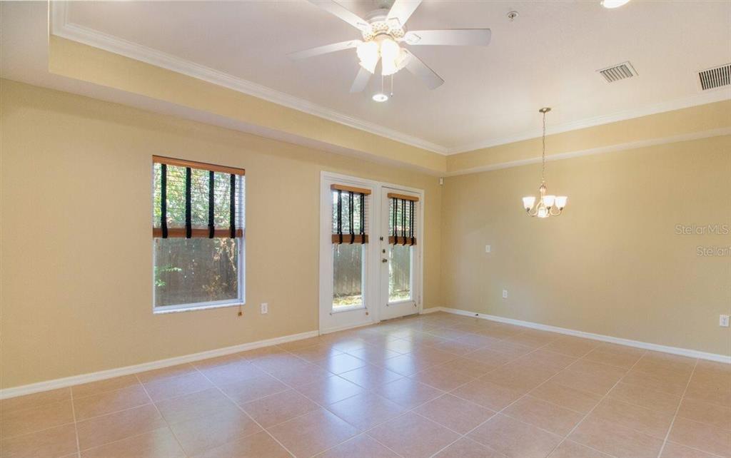 522 Northwest 39th Road, Unit 702 Gainesville, FL 32607 - Photo 4 of 15 a view of an empty room with window and wooden floor
