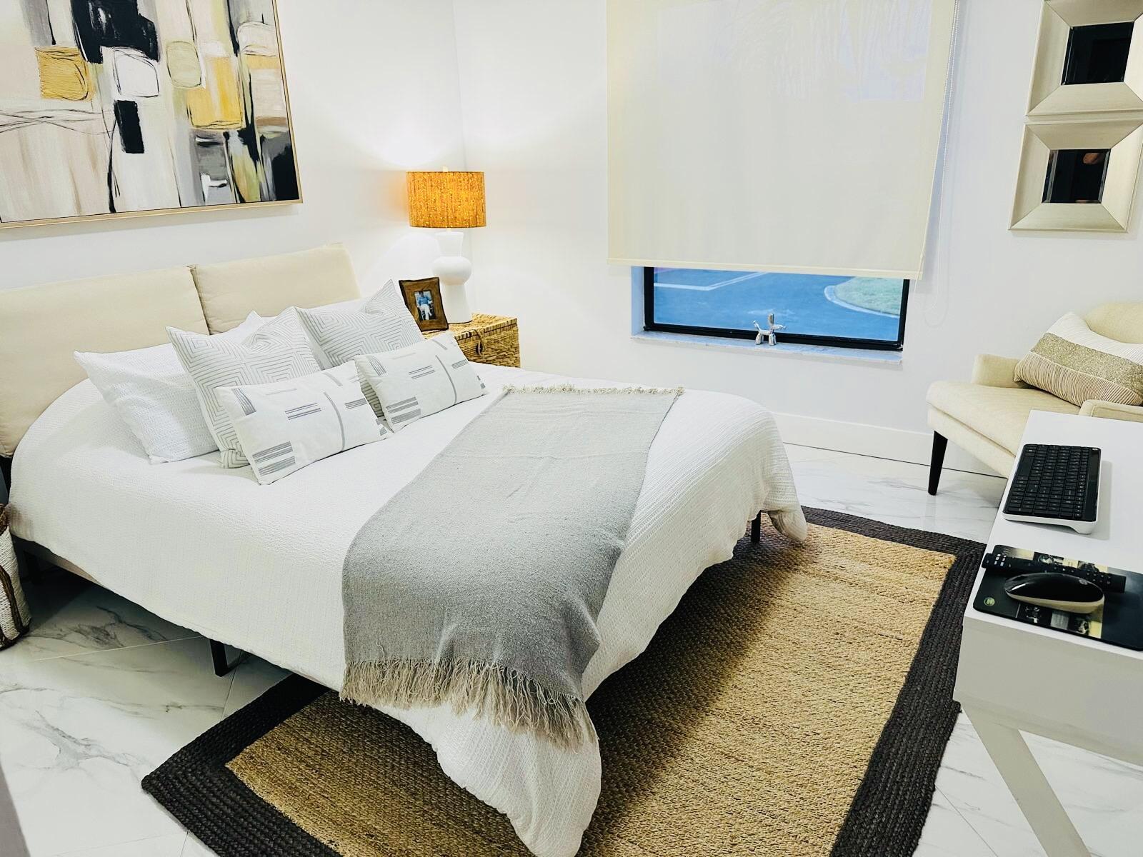 18266 Covina Way, Unit 201 Boca Raton, FL 33498 - Photo 3 of 6 a bedroom with a bed and a couch