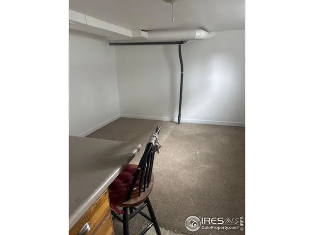 a room with a chair and appliances