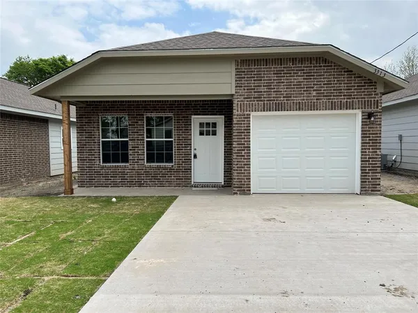 a front view of a house with a garden and yard