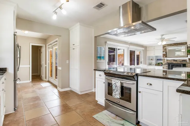 a kitchen with stainless steel appliances granite countertop a stove and cabinets