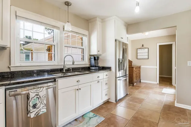 a kitchen with stainless steel appliances granite countertop a sink and a granite counter tops