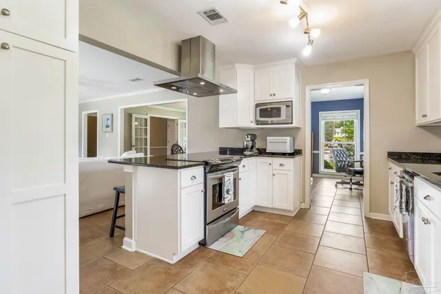 a kitchen with stainless steel appliances granite countertop a stove and a sink