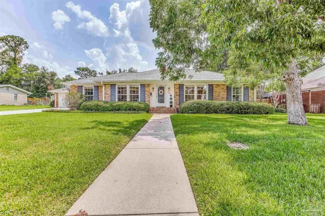 a front view of house with yard and green space