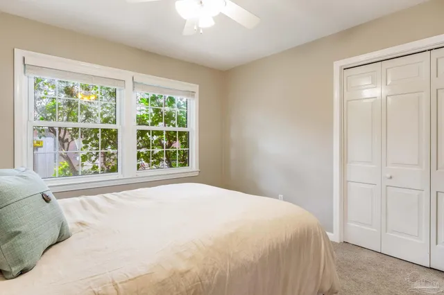 a bedroom with a bed and a window