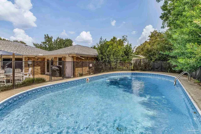 a view of a house with a yard and potted plants
