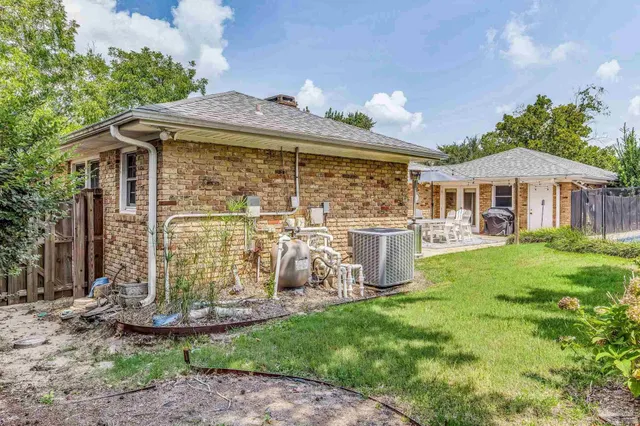 a view of a house with backyard porch and sitting area