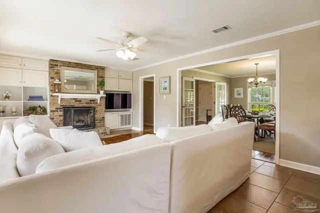 a living room with furniture fireplace and flat screen tv