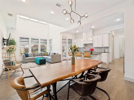 a dining room with furniture and wooden floor