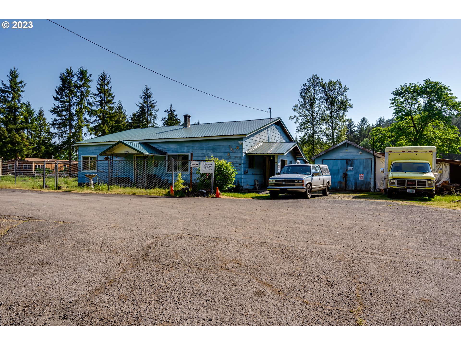 82531 Barbre Road Dexter, OR 97431 - Photo 3 of 18 a car parked in front of house with wooden fence