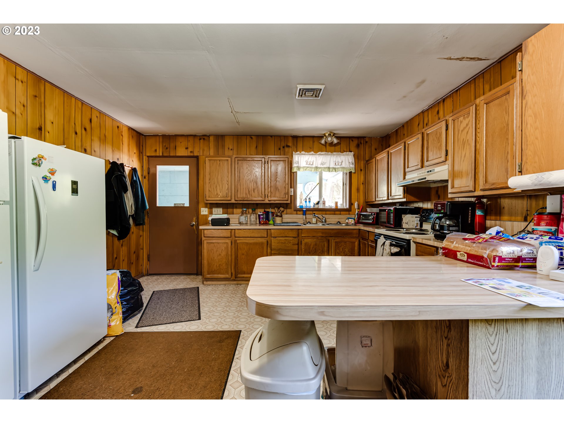 82531 Barbre Road Dexter, OR 97431 - Photo 8 of 18 a kitchen with stainless steel appliances wooden cabinets a center island and a refrigerator