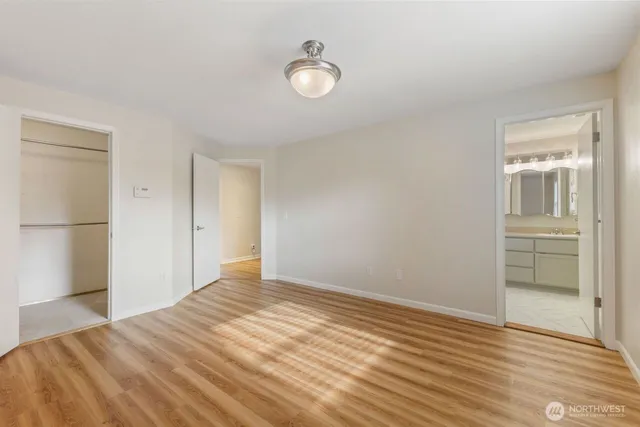 a view of a room with wooden floor and bathroom
