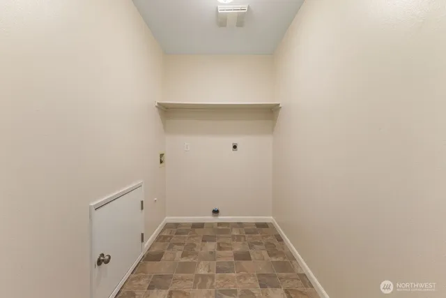 an empty room with closet and a chandelier fan